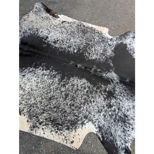 Black and white speckled large cowhide rug with textured surface for stylish home decor