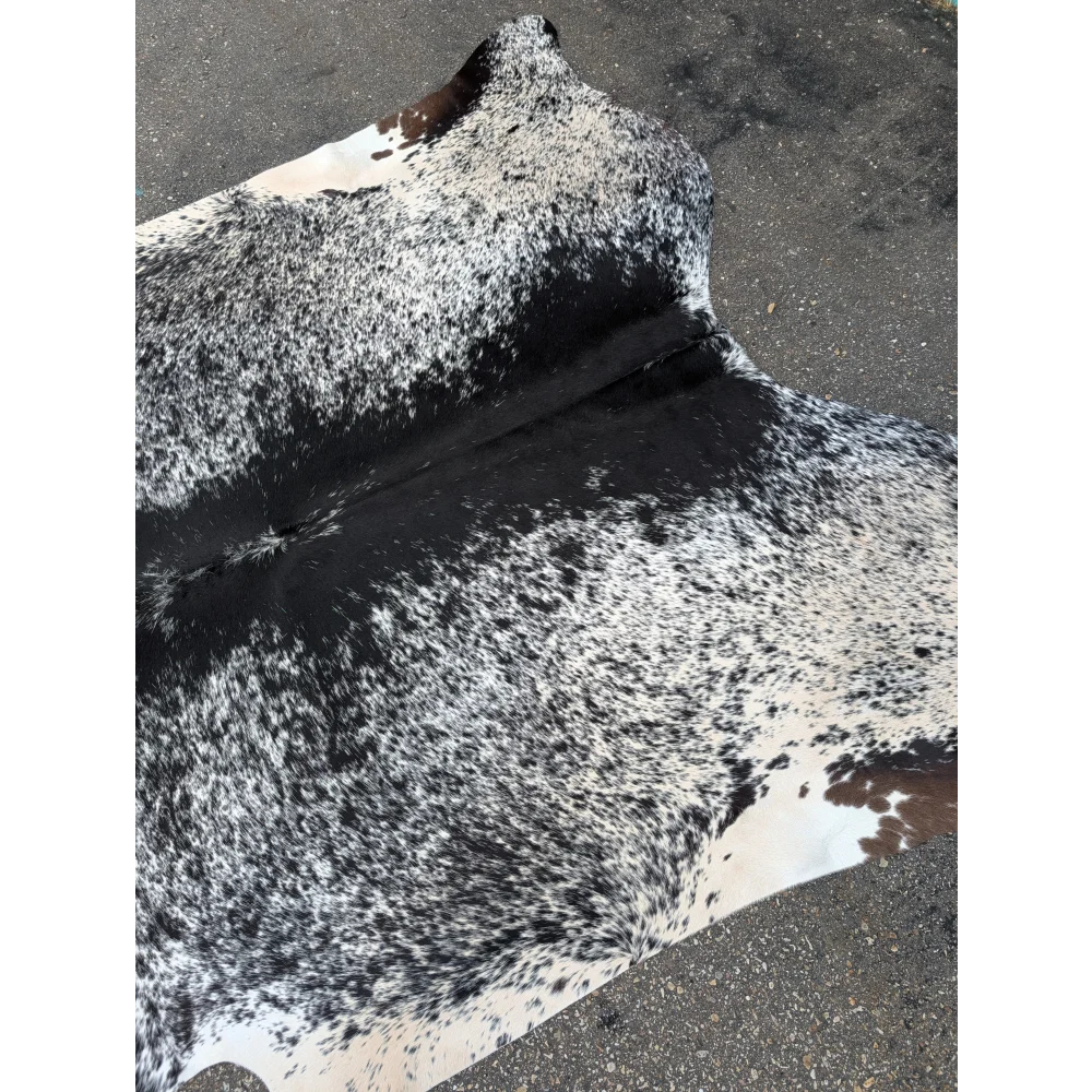 Large cowhide rug with black and white spots and leather texture for your space