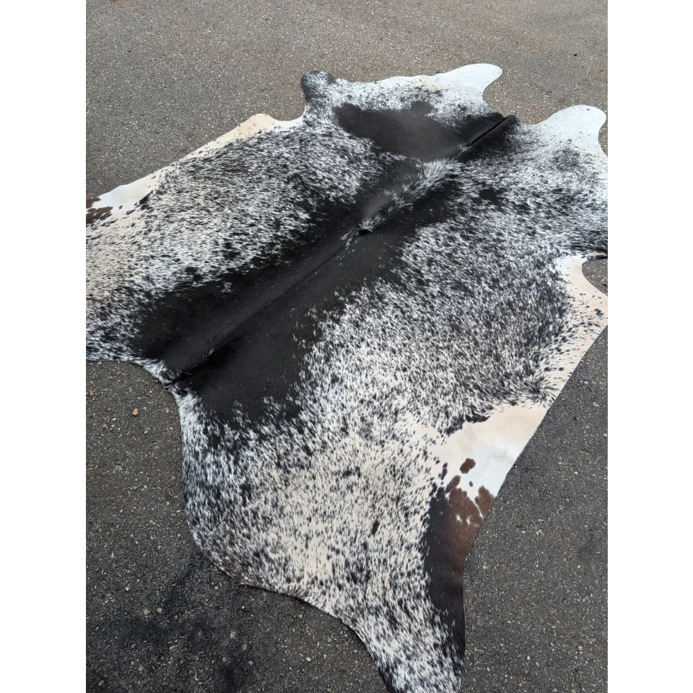 Large cowhide rug with black and white distressed cowhide texture for your space