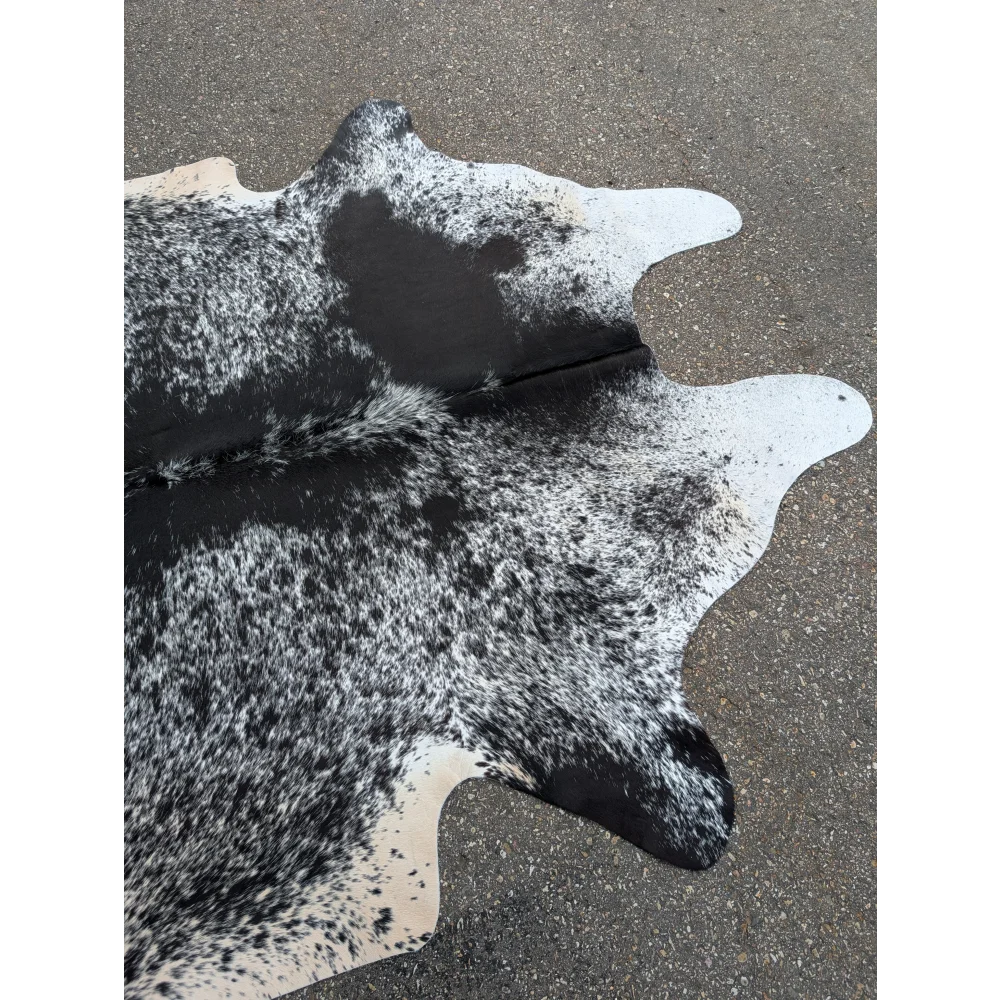 Large cowhide rug with black and white spots and leather texture for stylish homes