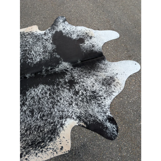 Large cowhide rug with black and white spots and leather texture for stylish homes