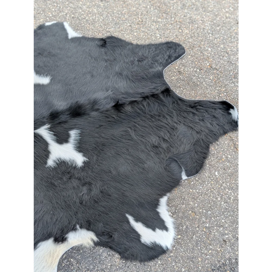 Large cowhide rug with black and white fur, natural texture for your space