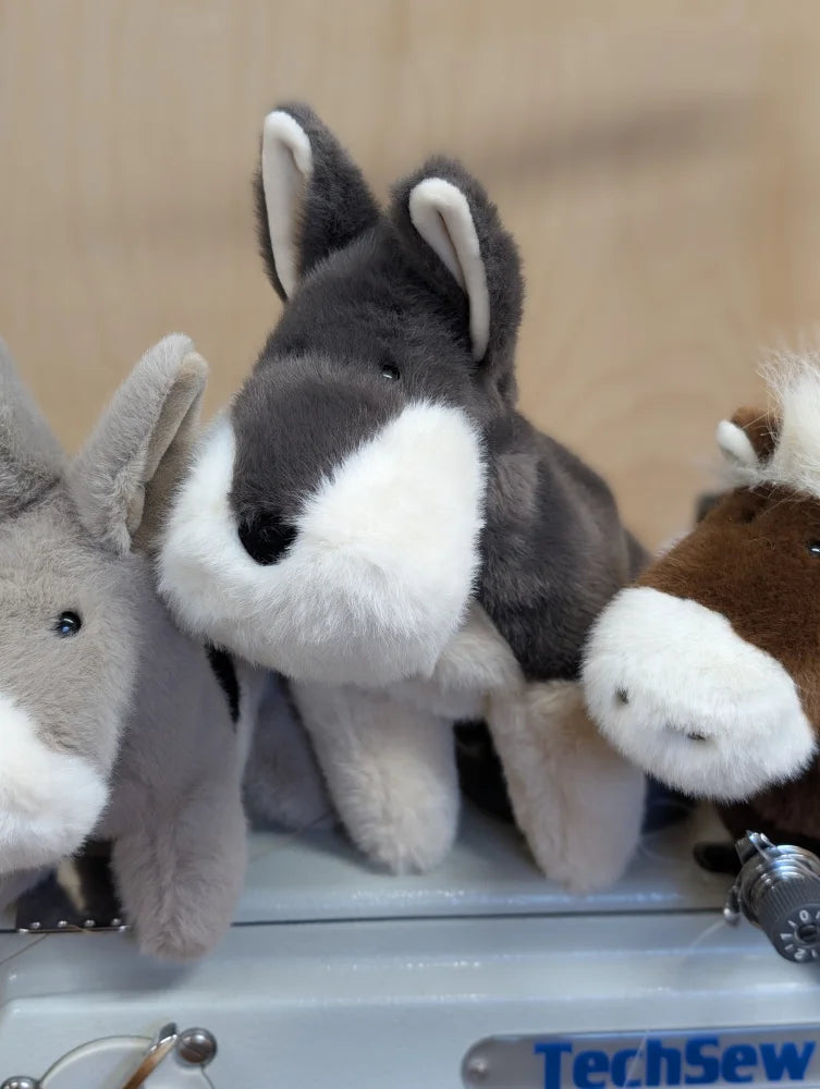 A plush gray and white donkey toy with soft fur and stitched nose from snuggable wolf dachshund toy collection