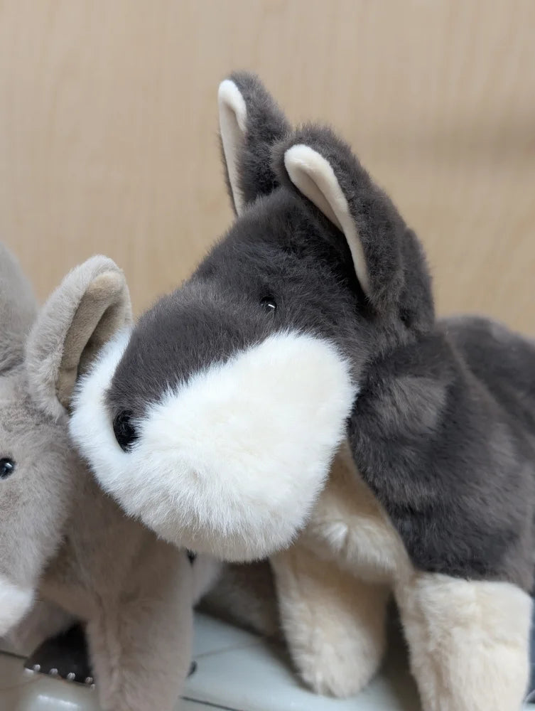 Snuggable wolf plush husky toy with soft gray and white fur, black button eyes, and beige inner ears, perfect dachshund toy alternative
