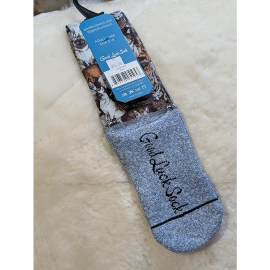Gray good luck socks with black stripe and text on Social Cats packaging