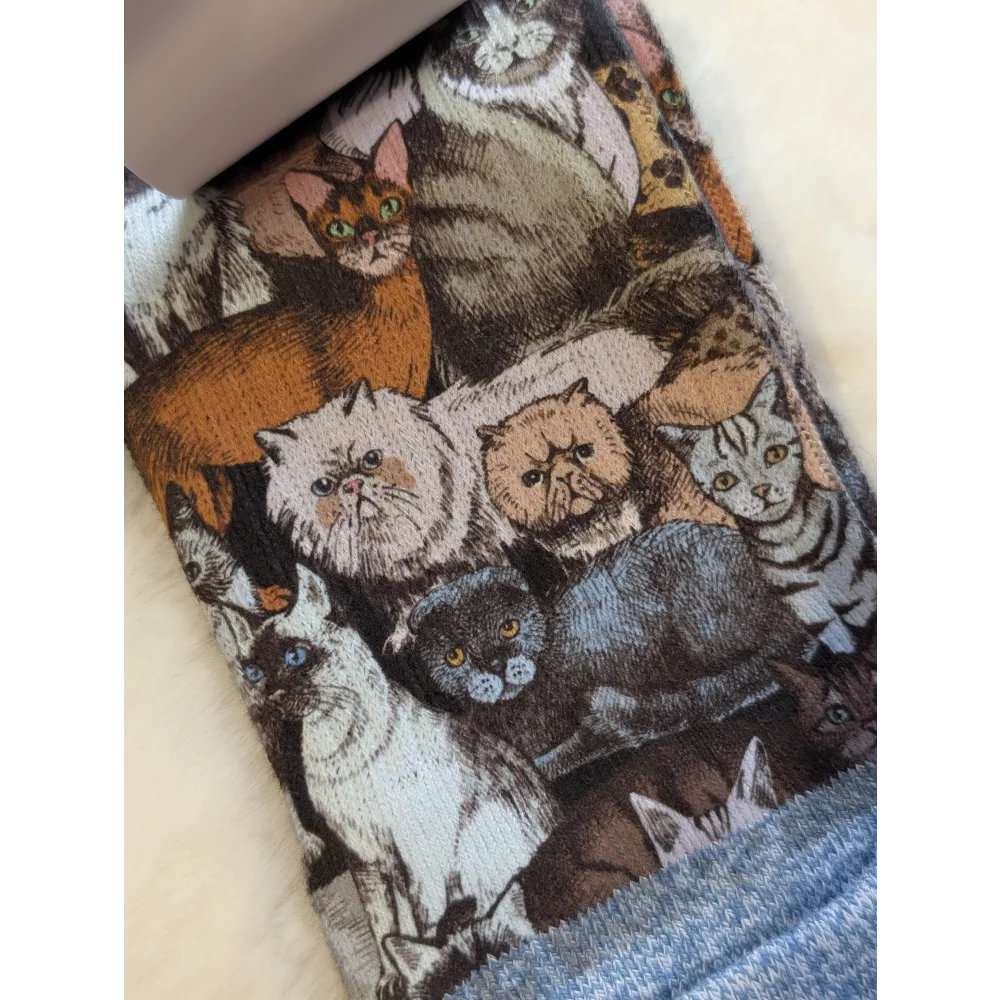 Cat-themed leggings by Good Luck Socks with colorful breeds