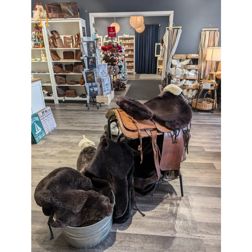Brown merino sheepskin western saddle cover with leather saddle, silver accents, floral design