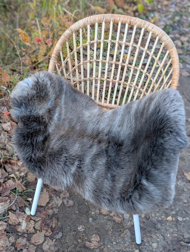 Gray faux fur chair cover with soft plush texture made from british isles sheepskin 40 by 24 inches