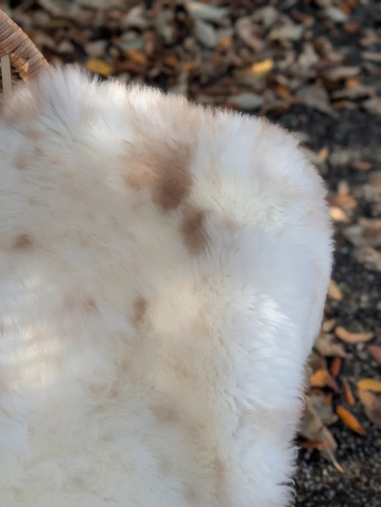 Softbrit#4 british isles sheepskin blanket with very soft white fur and subtle brown patches measuring 47 by 28 inches