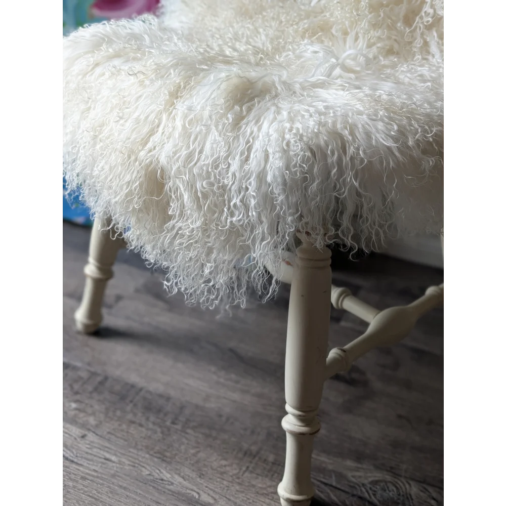 Gorgeous Angus Oliver Mongolian sheepskin stool with white fur and ornate wooden legs