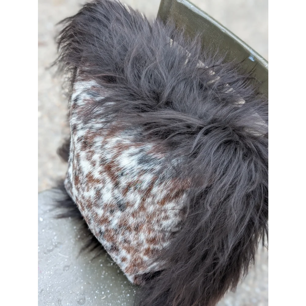 Cozy browny black icelandic hat with speckled natural cowhide fabric and dark gray faux fur lining perfect for long wool days