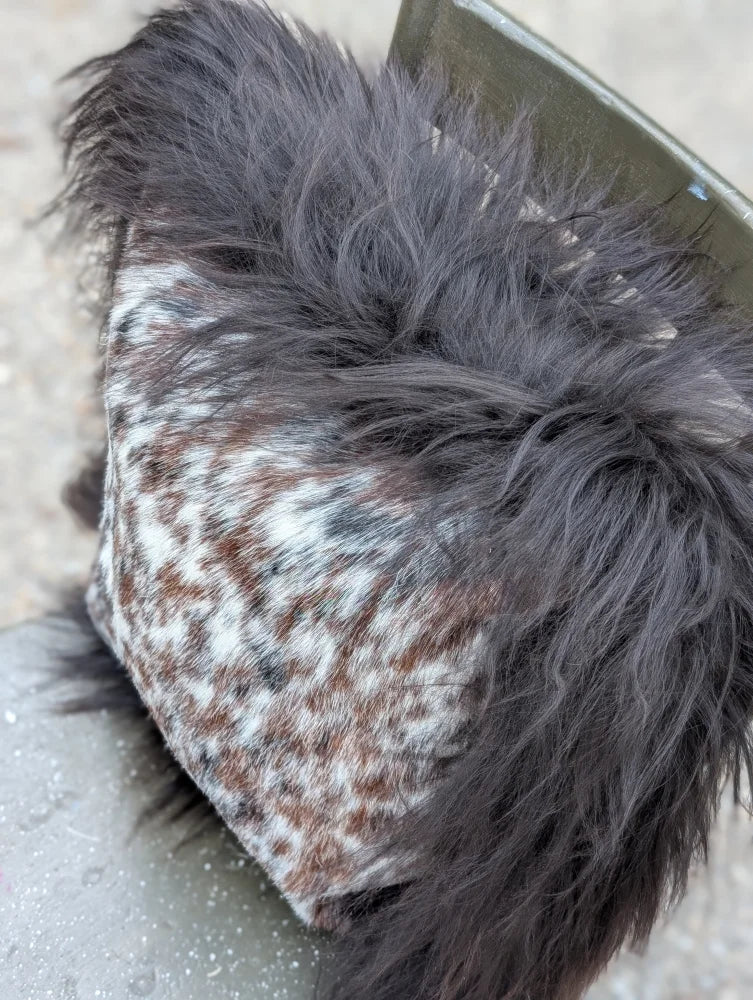 Cozy browny black icelandic hat with speckled natural cowhide fabric and dark gray faux fur lining perfect for long wool days