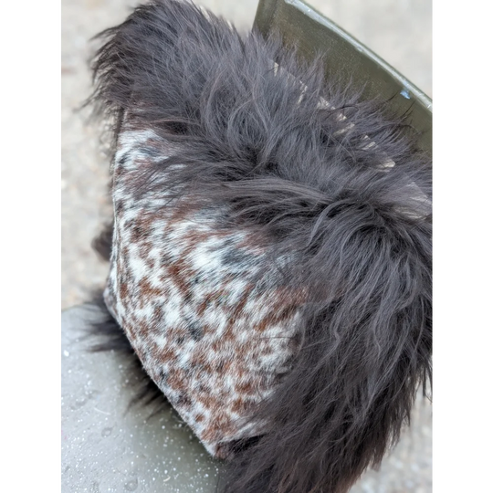 Cozy browny black icelandic hat with speckled natural cowhide fabric and dark gray faux fur lining perfect for long wool days