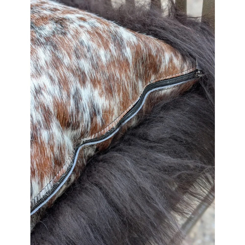 Brown and white spotted natural cowhide pillow with black zipper perfect for long wool décor and sewing machines users