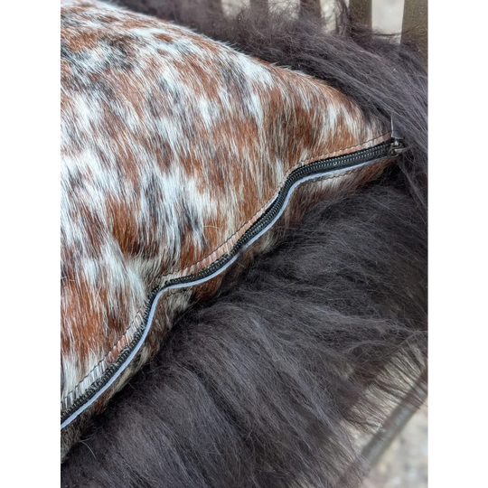 Brown and white spotted natural cowhide pillow with black zipper perfect for long wool décor and sewing machines users