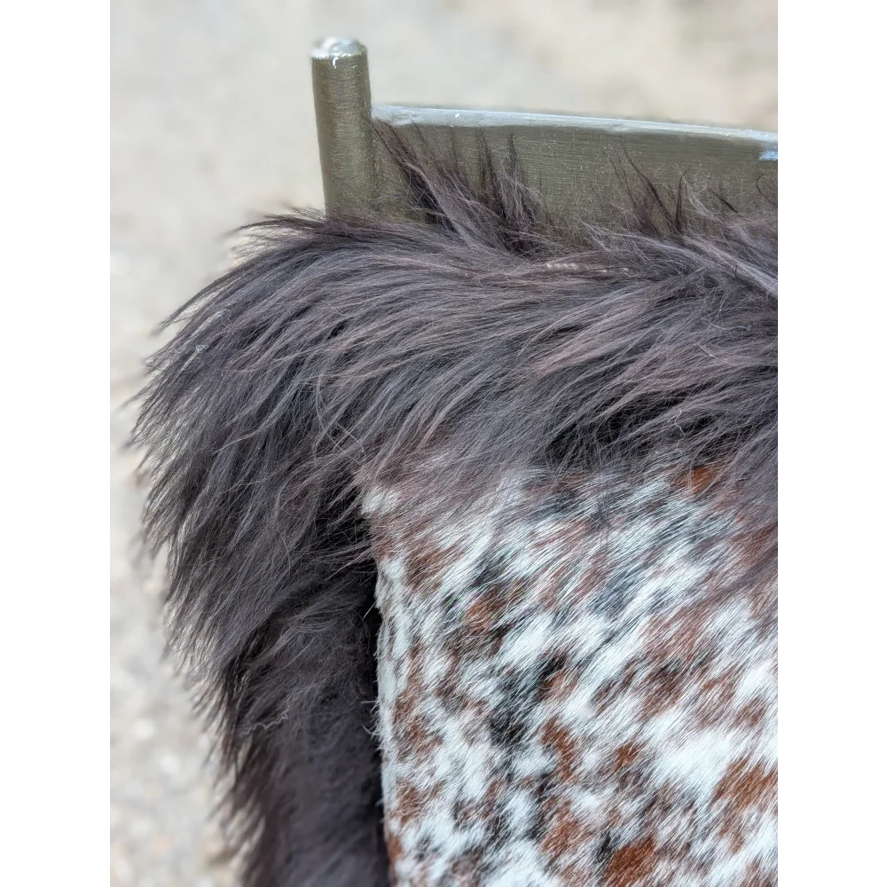 Speckled cowhide pillow with dark brown fluffy faux fur trim and long wool detail perfect for sewing machines projects