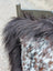 Speckled cowhide pillow with dark brown fluffy faux fur trim and long wool detail perfect for sewing machines projects
