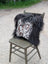 Black and white speckled natural cowhide pillow with long wool black shaggy trim perfect for sewing machines decor