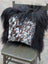 Black and white natural cowhide pillow with long wool black fur trim from the speckled cowhide and natural black icelandic collection
