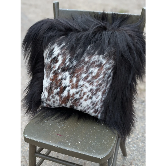Black and white natural cowhide pillow with long wool black fur trim from the speckled cowhide and natural black icelandic collection