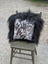 Black and white natural cowhide pillow with fluffy black long wool trim from speckled cowhide and natural black icelandic