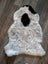 A plush icelandic sheepskin rug with short wool, creamy white base, and two black patches, medium size 39 by 25.5 inches