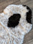 Plush irregular icelandic sheepskin rug with natural white and black short wool curly fur 39 by 25.5 inches
