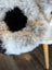 A plush gray and white icelandic sheepskin rug with short wool and a central black patch spot10 39 x 25.5 inches