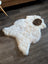 White icelandic sheepskin rug with a brown patch featuring short wool perfect for cozy home decor
