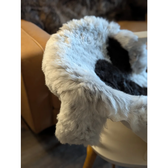 White and black faux fur throw blanket with plush texture made from medium spotted icelandic sheepskin short wool