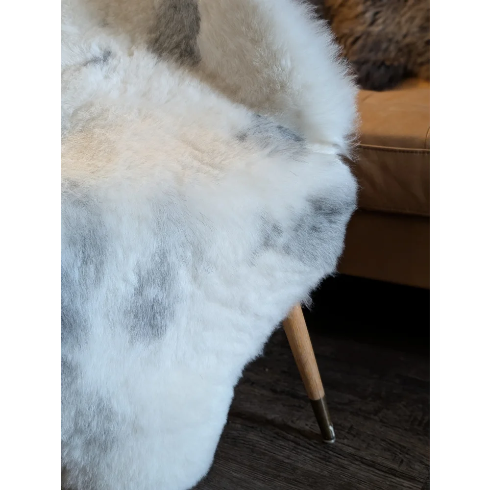 White and gray speckled faux fur throw blanket inspired by large spotted icelandic sheepskins with short wool texture