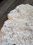 Cream icelandic sheepskin rug with soft short wool and dark gray speckles perfect for cozy decor