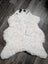 Large soft spotted icelandic sheepskin rug with white fluffy wool and natural black markings on head and shoulders