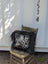 Black and white spotted cowhide pillow with long wool icelandic sheepskin trim perfect for cozy decor
