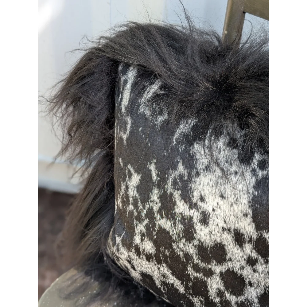 Black and white spotted cowhide pillow with fluffy natural black Icelandic sheepskin long wool trim perfect for sewing machines