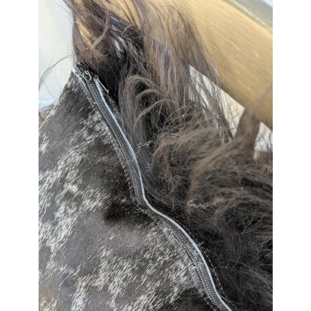 Spotted cowhide zipper pull with black and white pattern and silver metal slider perfect for icelandic sheepskin projects
