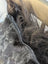 Spotted cowhide zipper pull with black and white pattern and silver metal slider perfect for icelandic sheepskin projects