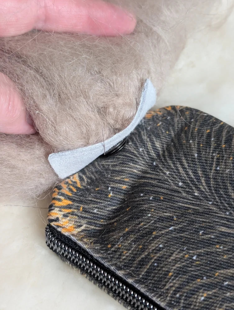 Black and orange tiger-print cotton canvas squirrel coin purse with silver zipper and sheepskin tail detail