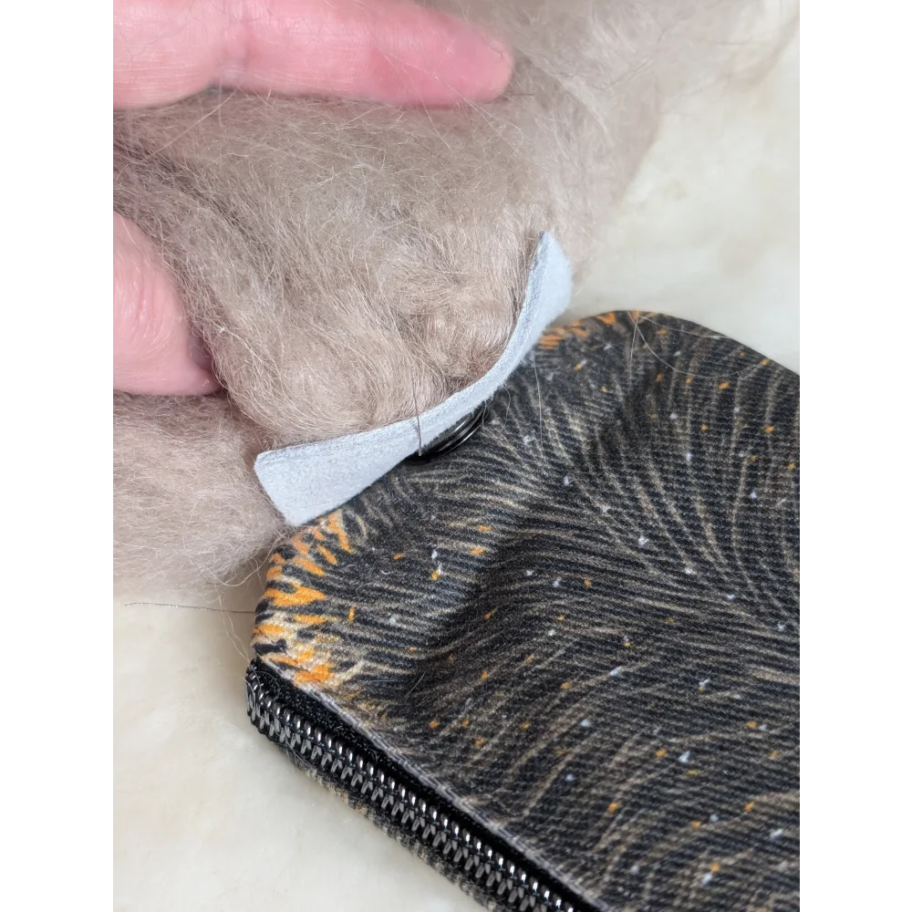 Black and orange tiger-print cotton canvas squirrel coin purse with silver zipper and sheepskin tail detail