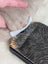 Black and orange tiger-print cotton canvas squirrel coin purse with silver zipper and sheepskin tail detail
