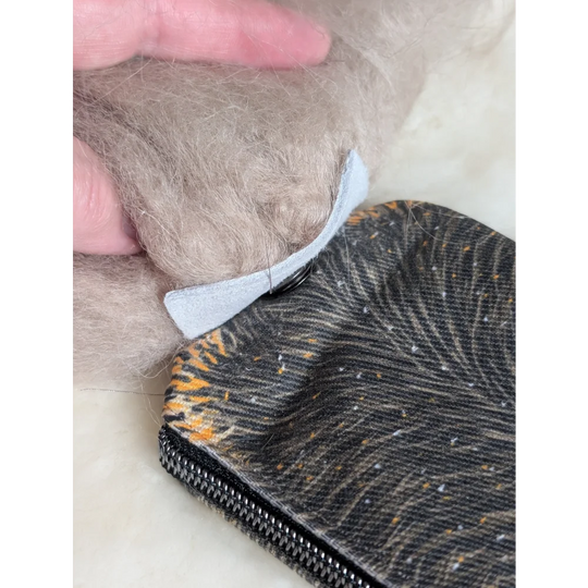 Black and orange tiger-print cotton canvas squirrel coin purse with silver zipper and sheepskin tail detail