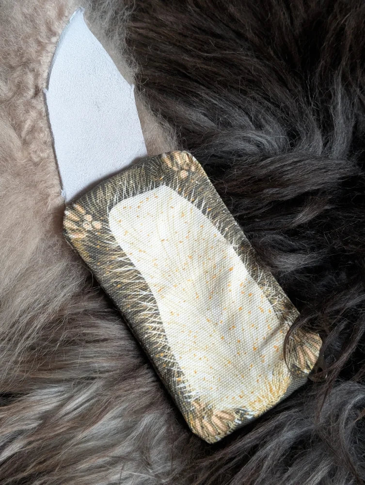 Squirrel coin purse made of olive green cotton canvas with cream floral edges and a soft sheepskin tail detail