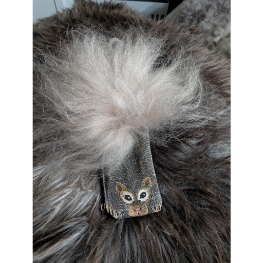 A charming dark gray coin purse with a cute squirrel face and fluffy white sheepskin tail pom-pom on cotton canvas