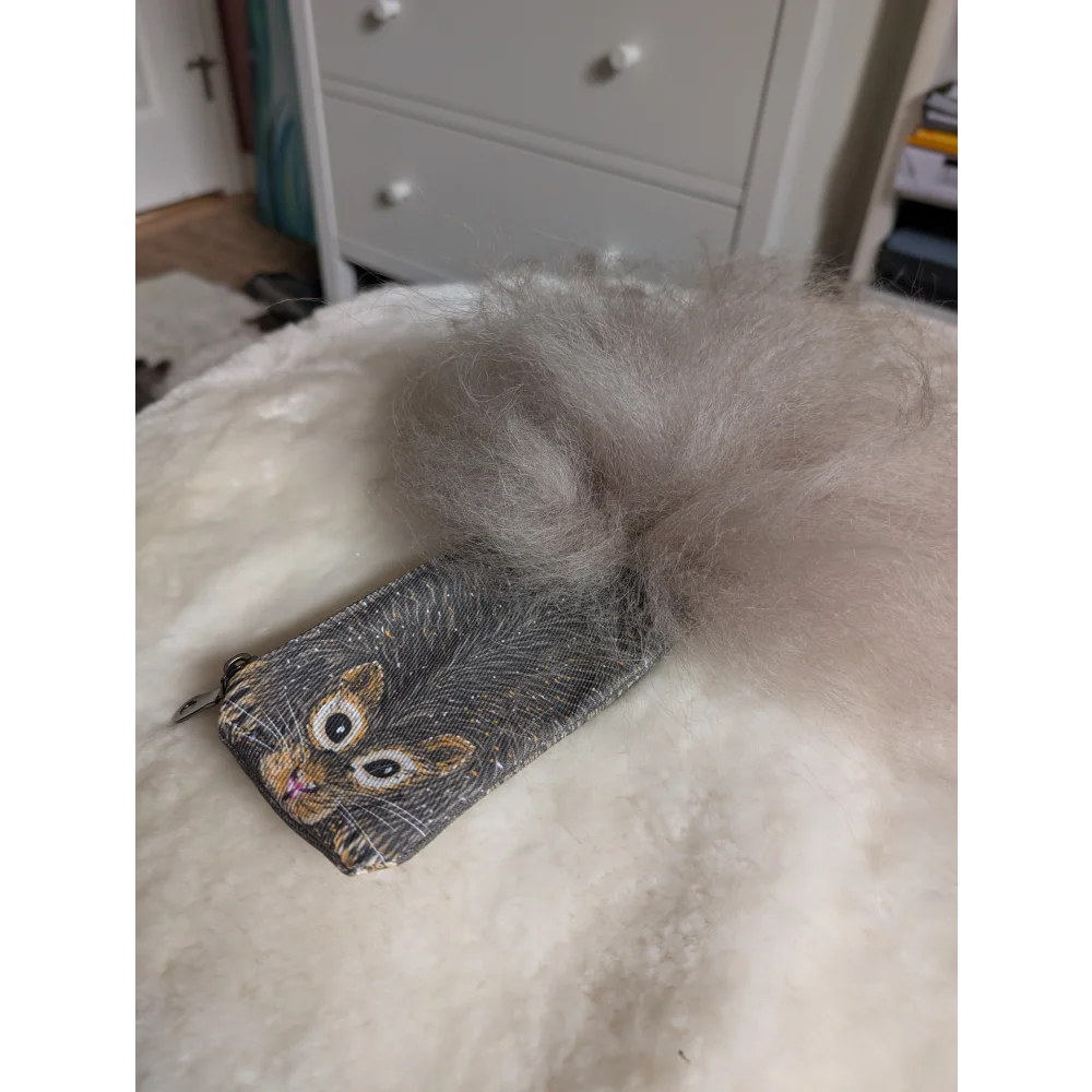 Gray squirrel coin purse made of cotton canvas with a fluffy sheepskin tail attachment for storing coins