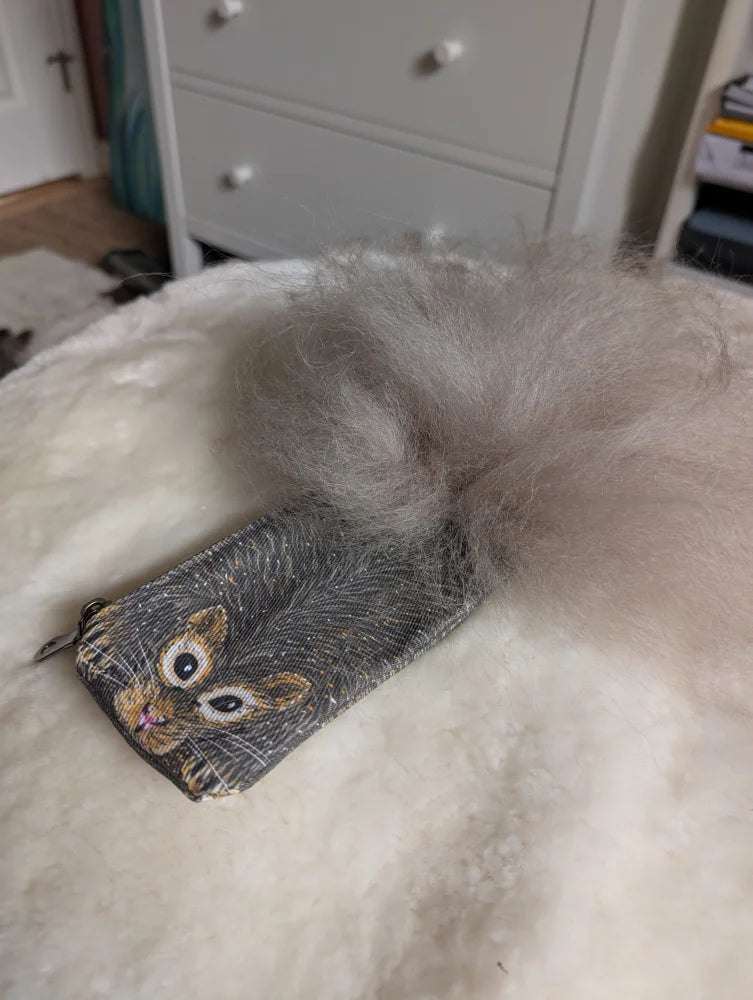 Gray squirrel coin purse made of cotton canvas with a fluffy sheepskin tail attachment for storing coins