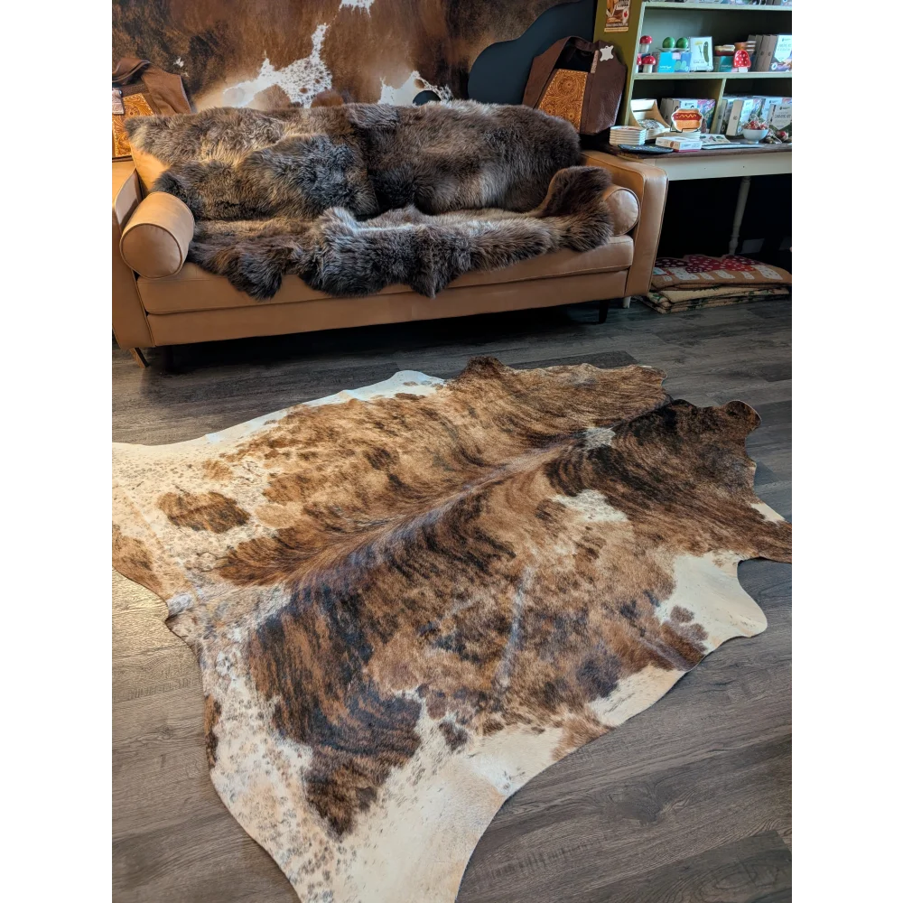 Large brown and white cowhide rug with beautiful irregular natural patterns showcasing unique characteristics
