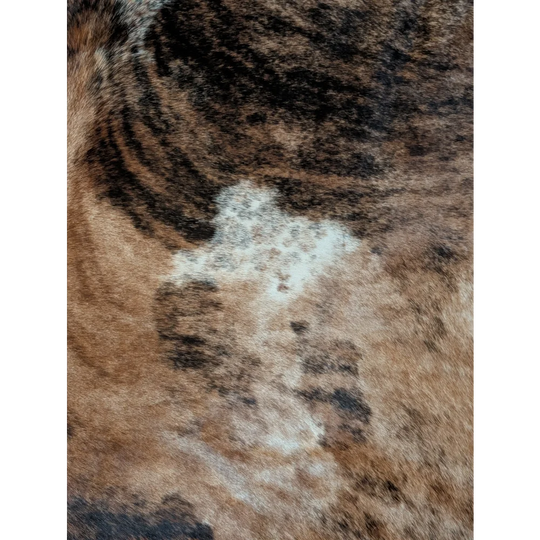 A large cowhide rug featuring fluffy brown and black tabby fur with unique white markings for beautiful rugs