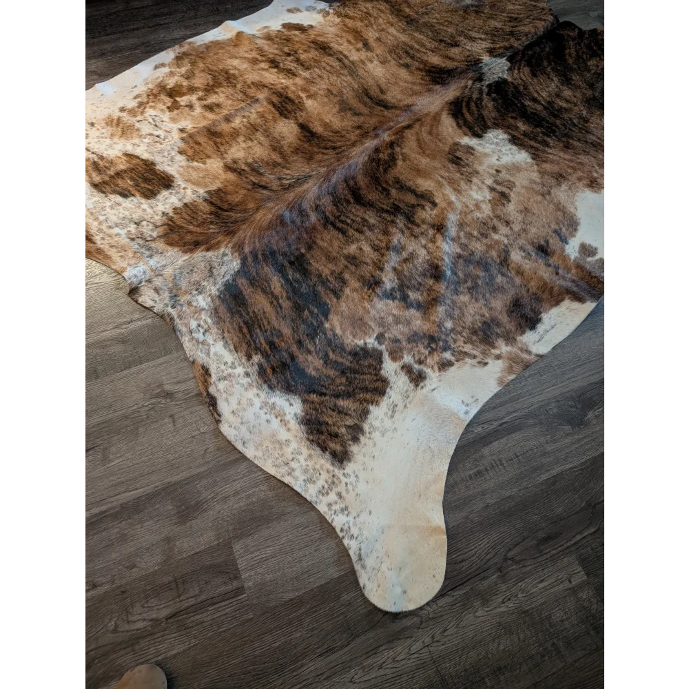 Large cowhide rug in brown and white with natural irregular patterns showcasing beautiful rugs unique characteristics