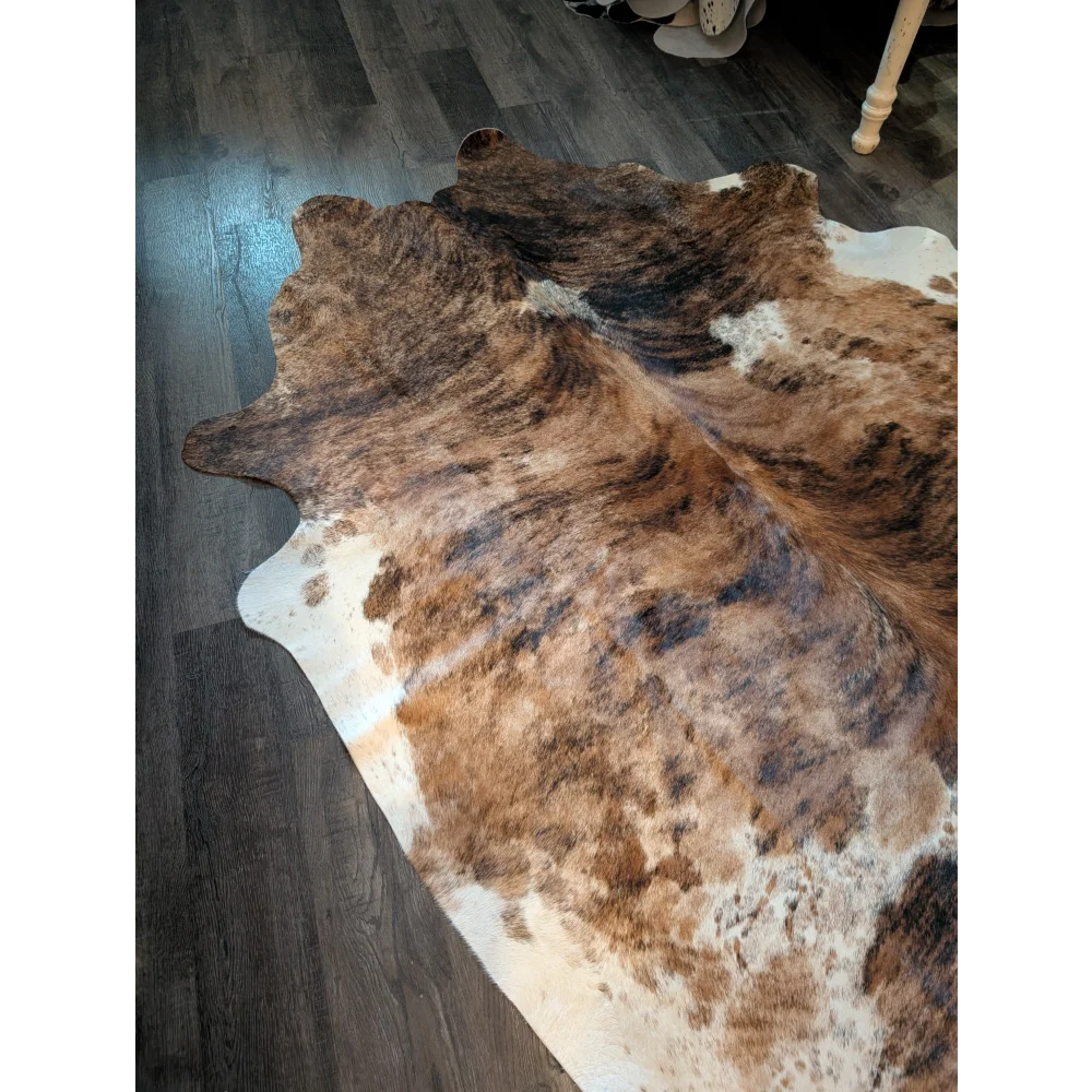 Large brown and white cowhide rug with beautiful natural irregular patterns and unique characteristics perfect for decor