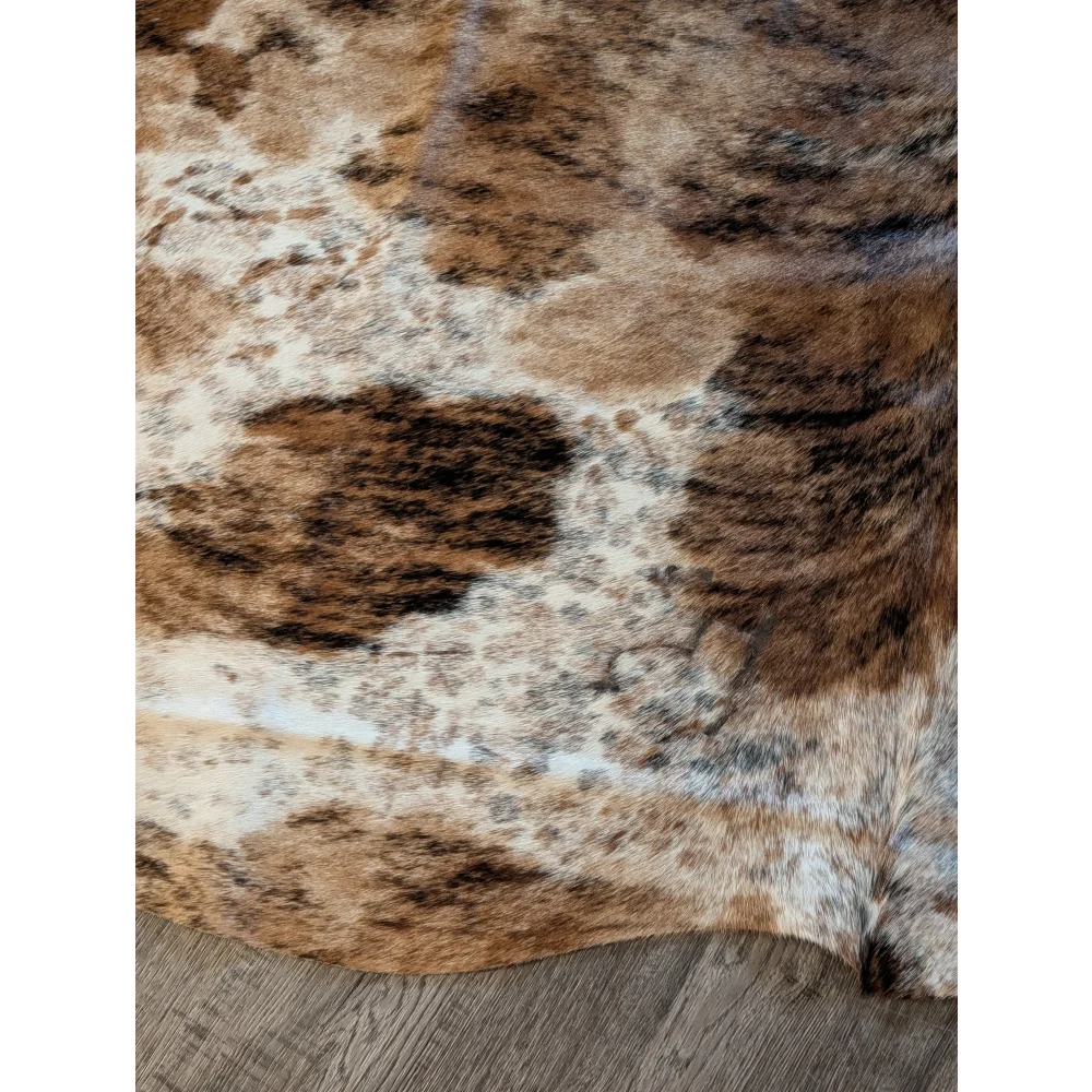 Brown and white large cowhide rug with natural fur texture showcasing unique characteristics for beautiful rugs